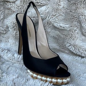 Nicholas Kirkwood black sling-back heals with signature pearl platform.